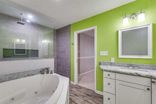 full bath featuring vanity, wood finished floors, baseboards, a whirlpool tub, and a walk in shower