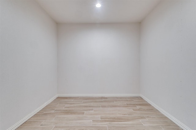 empty room with baseboards and wood finish floors