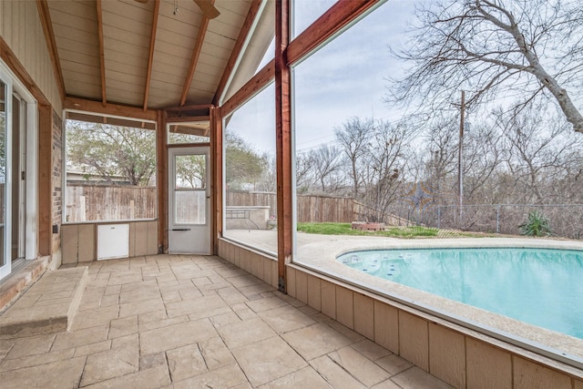 unfurnished sunroom with lofted ceiling with beams