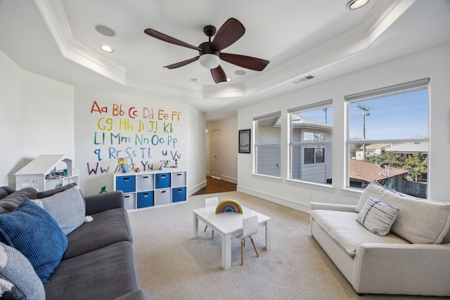 living room with visible vents, ornamental molding, a tray ceiling, recessed lighting, and baseboards