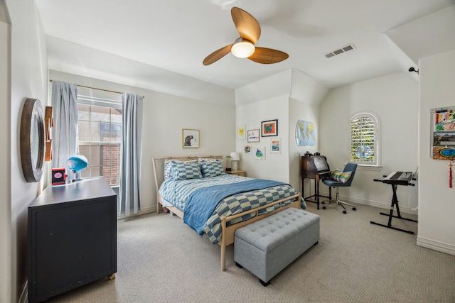 carpeted bedroom featuring visible vents, multiple windows, baseboards, and ceiling fan