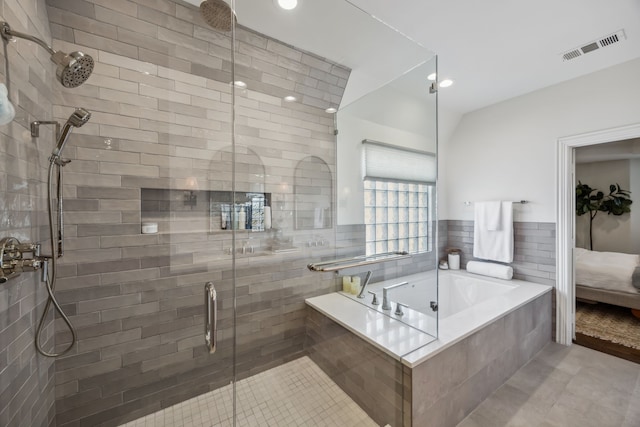 bathroom featuring a garden tub, visible vents, a shower stall, and connected bathroom