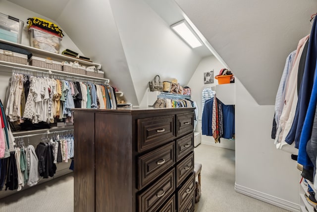 spacious closet with lofted ceiling and carpet floors