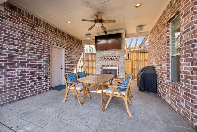 view of patio / terrace with area for grilling, outdoor dining area, fence, and ceiling fan