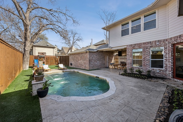 view of pool with a lawn, a patio, a fenced backyard, a playground, and a fenced in pool