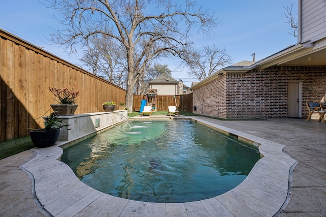 view of swimming pool with a patio area, a fenced backyard, and a fenced in pool