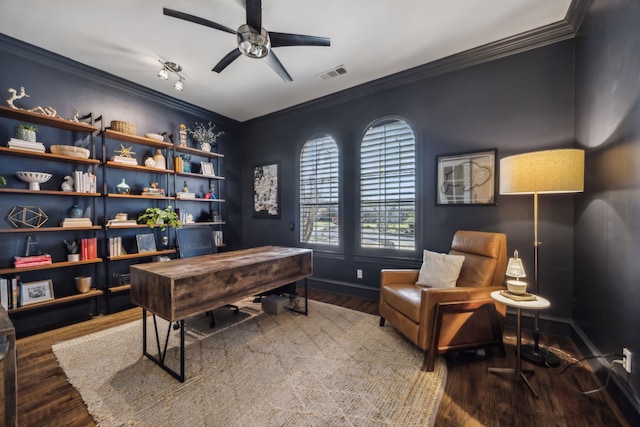 office space with visible vents, a ceiling fan, wood finished floors, crown molding, and baseboards