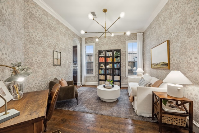 living area featuring arched walkways, wallpapered walls, crown molding, and hardwood / wood-style floors