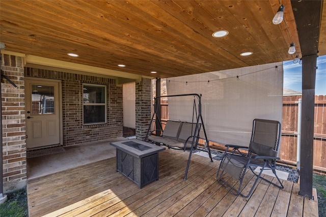 wooden deck featuring an outdoor fire pit