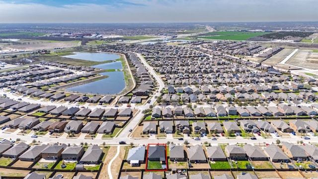 drone / aerial view featuring a water view and a residential view