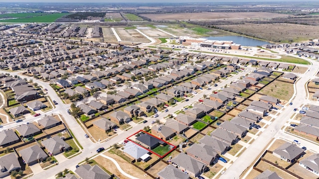 drone / aerial view featuring a residential view and a water view