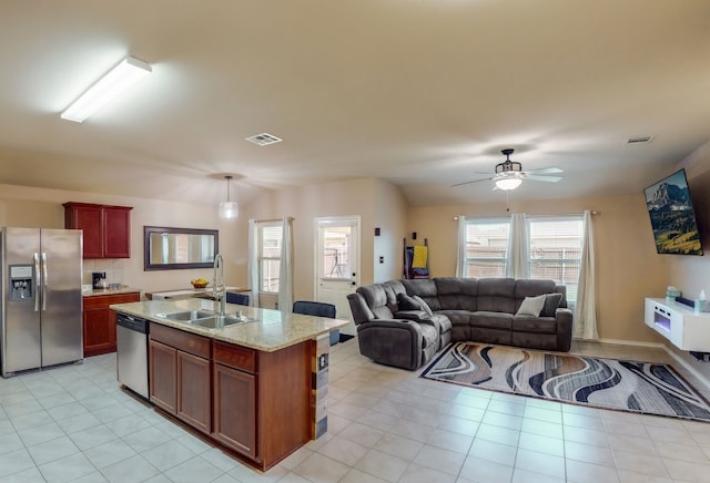 kitchen featuring visible vents, a sink, ceiling fan, stainless steel appliances, and open floor plan