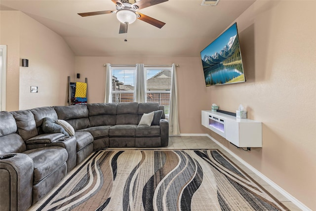 living room featuring visible vents, baseboards, a ceiling fan, and vaulted ceiling