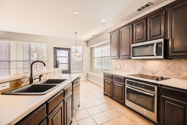 kitchen featuring visible vents, a sink, light countertops, appliances with stainless steel finishes, and tasteful backsplash