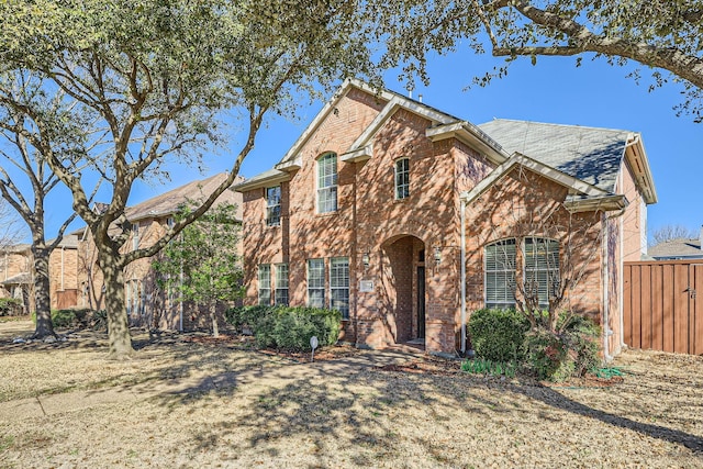 traditional-style home with brick siding