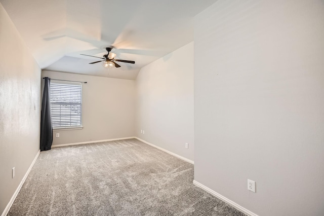 carpeted spare room featuring a ceiling fan and baseboards