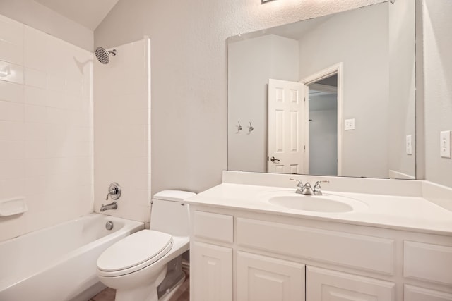 full bath featuring lofted ceiling, toilet, vanity, and shower / bathing tub combination