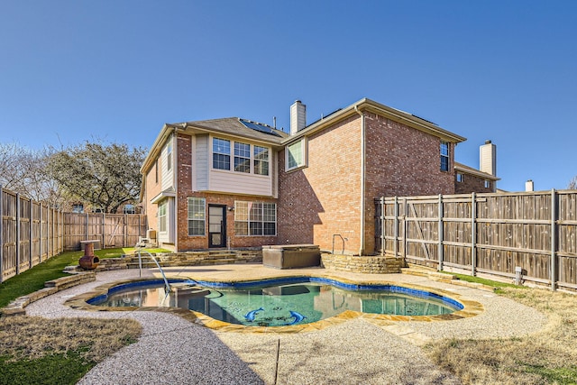 view of swimming pool featuring a patio area, a fenced in pool, an outdoor hot tub, and a fenced backyard