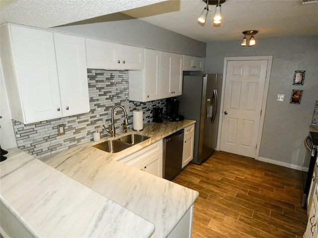 kitchen featuring tasteful backsplash, stainless steel fridge with ice dispenser, dishwasher, white cabinets, and a sink