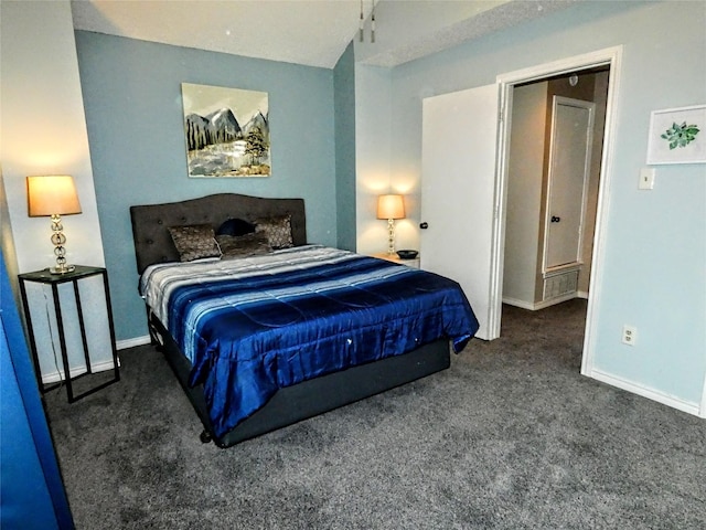 carpeted bedroom with lofted ceiling and baseboards