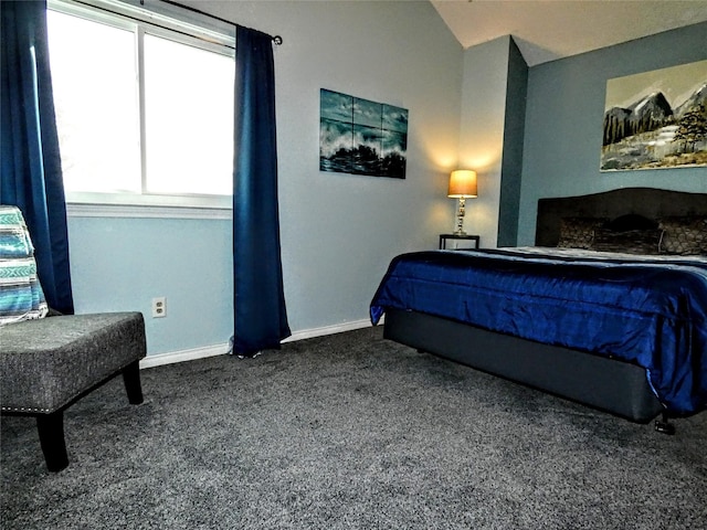 bedroom featuring baseboards, dark carpet, and vaulted ceiling