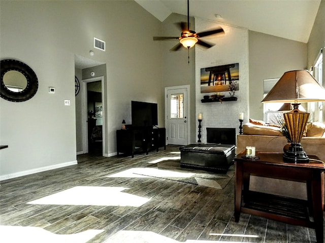 living room featuring visible vents, baseboards, wood tiled floor, lofted ceiling, and a ceiling fan