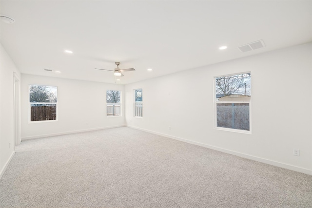 carpeted spare room featuring recessed lighting, visible vents, and baseboards