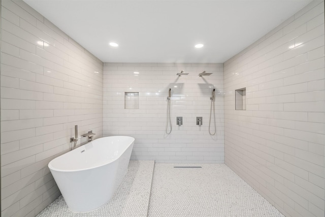 bathroom featuring recessed lighting, tiled shower, a soaking tub, and tile walls