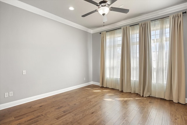 spare room with wood finished floors, recessed lighting, crown molding, baseboards, and ceiling fan