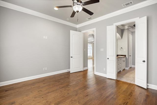 unfurnished bedroom featuring wood finished floors, visible vents, and ornamental molding