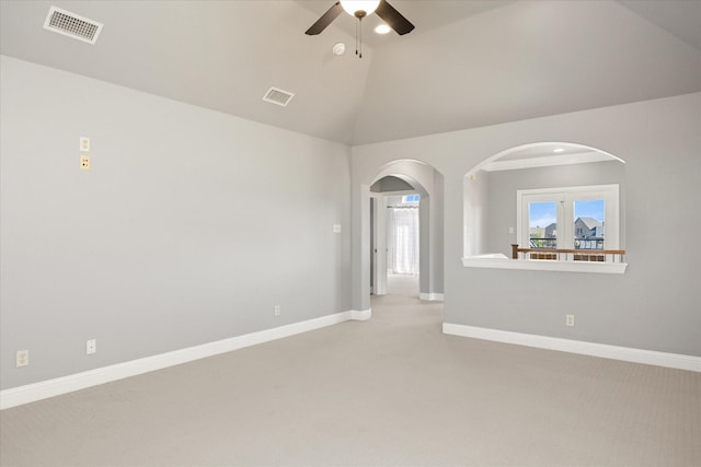 empty room featuring vaulted ceiling, baseboards, visible vents, and ceiling fan