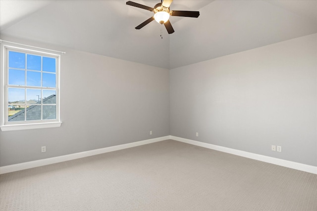 spare room with lofted ceiling, a ceiling fan, baseboards, and carpet floors