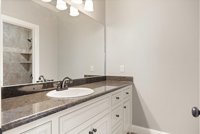 full bath with baseboards and vanity