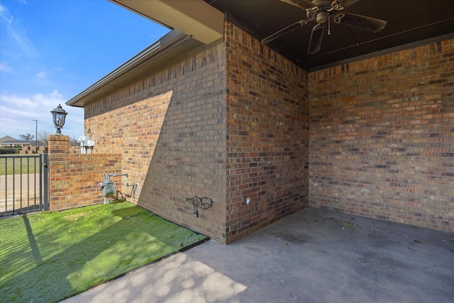 view of patio with a ceiling fan and fence