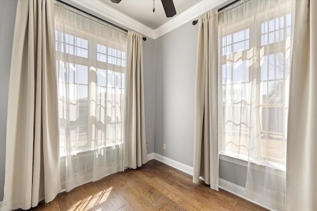 doorway to outside with dark wood-style floors, plenty of natural light, baseboards, and ornamental molding