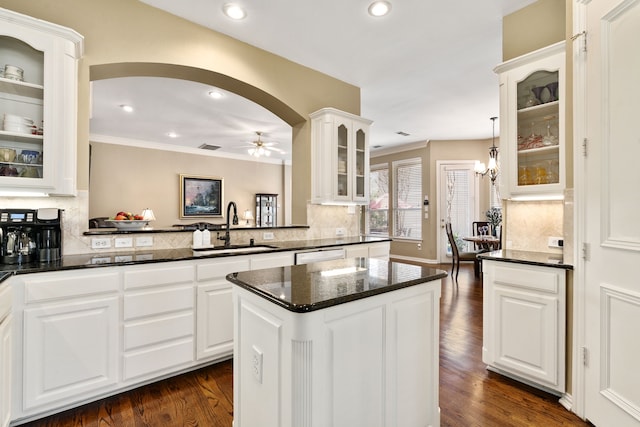 kitchen featuring a sink, tasteful backsplash, dark wood finished floors, and ceiling fan with notable chandelier