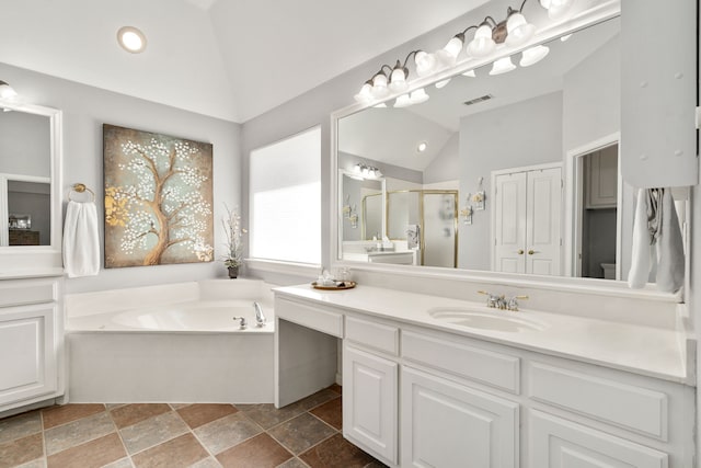 full bath with visible vents, a garden tub, a stall shower, lofted ceiling, and vanity