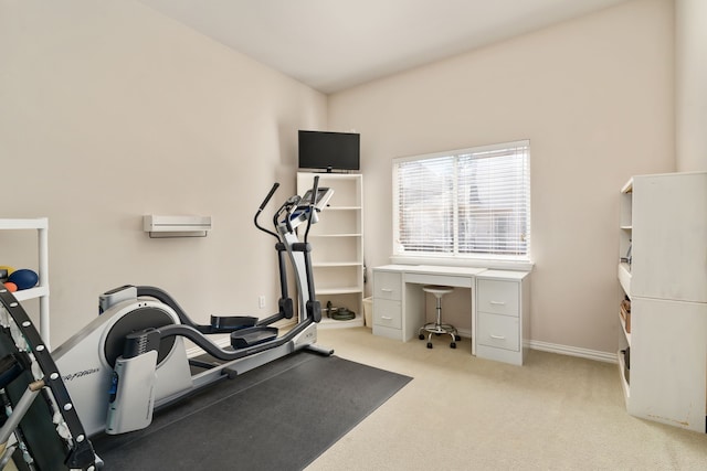 exercise room featuring light carpet and baseboards