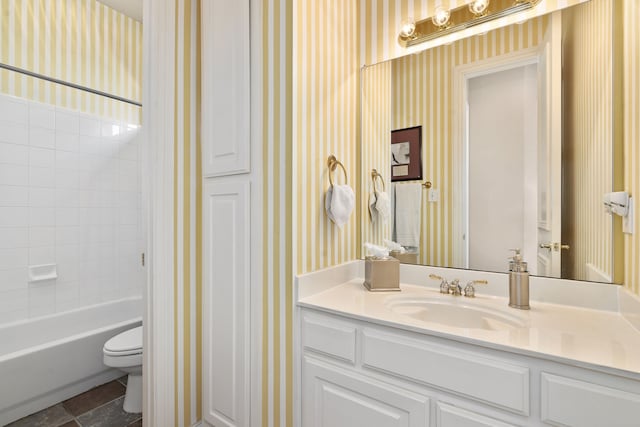 bathroom with shower / bathing tub combination, toilet, vanity, and wallpapered walls