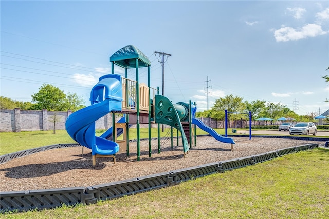 community playground with a lawn and fence