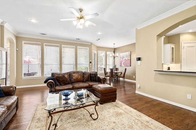 living area featuring dark wood-type flooring, baseboards, and ornamental molding