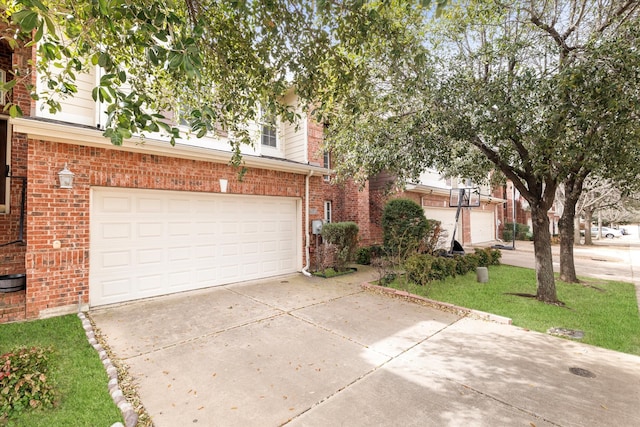 view of front facade with brick siding and concrete driveway