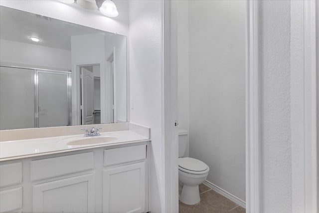 bathroom with tile patterned flooring, toilet, vanity, and a stall shower