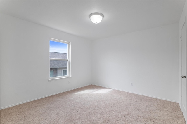 carpeted spare room with baseboards