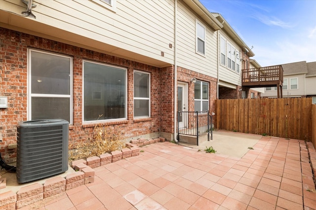 view of patio / terrace featuring central AC and fence