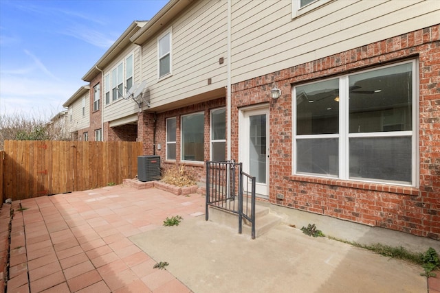 view of patio / terrace featuring central air condition unit and fence