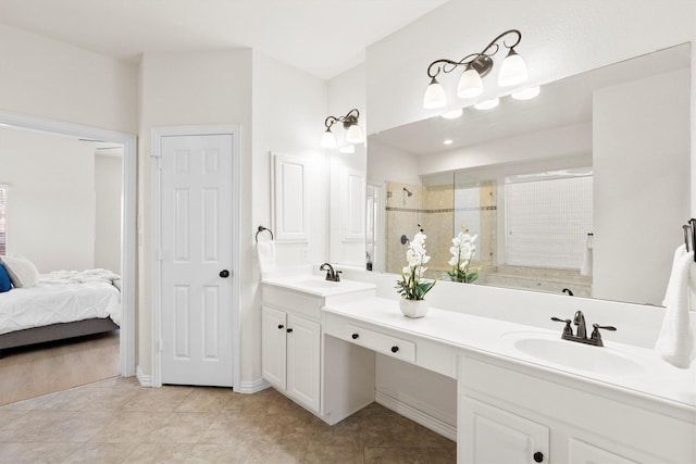 ensuite bathroom with double vanity, a shower stall, ensuite bath, and a sink