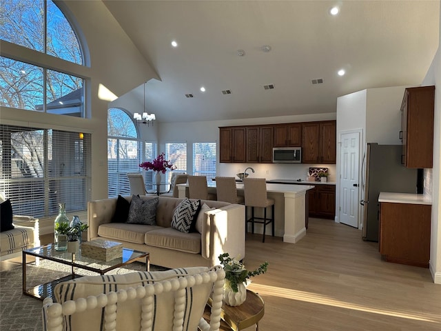 living room with an inviting chandelier, recessed lighting, visible vents, and light wood finished floors