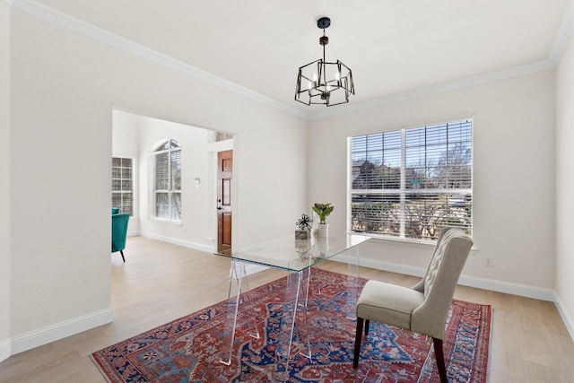 interior space featuring baseboards, a notable chandelier, wood finished floors, and ornamental molding