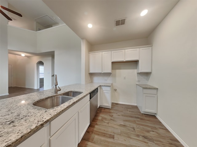 kitchen with visible vents, a sink, white cabinets, a ceiling fan, and stainless steel dishwasher